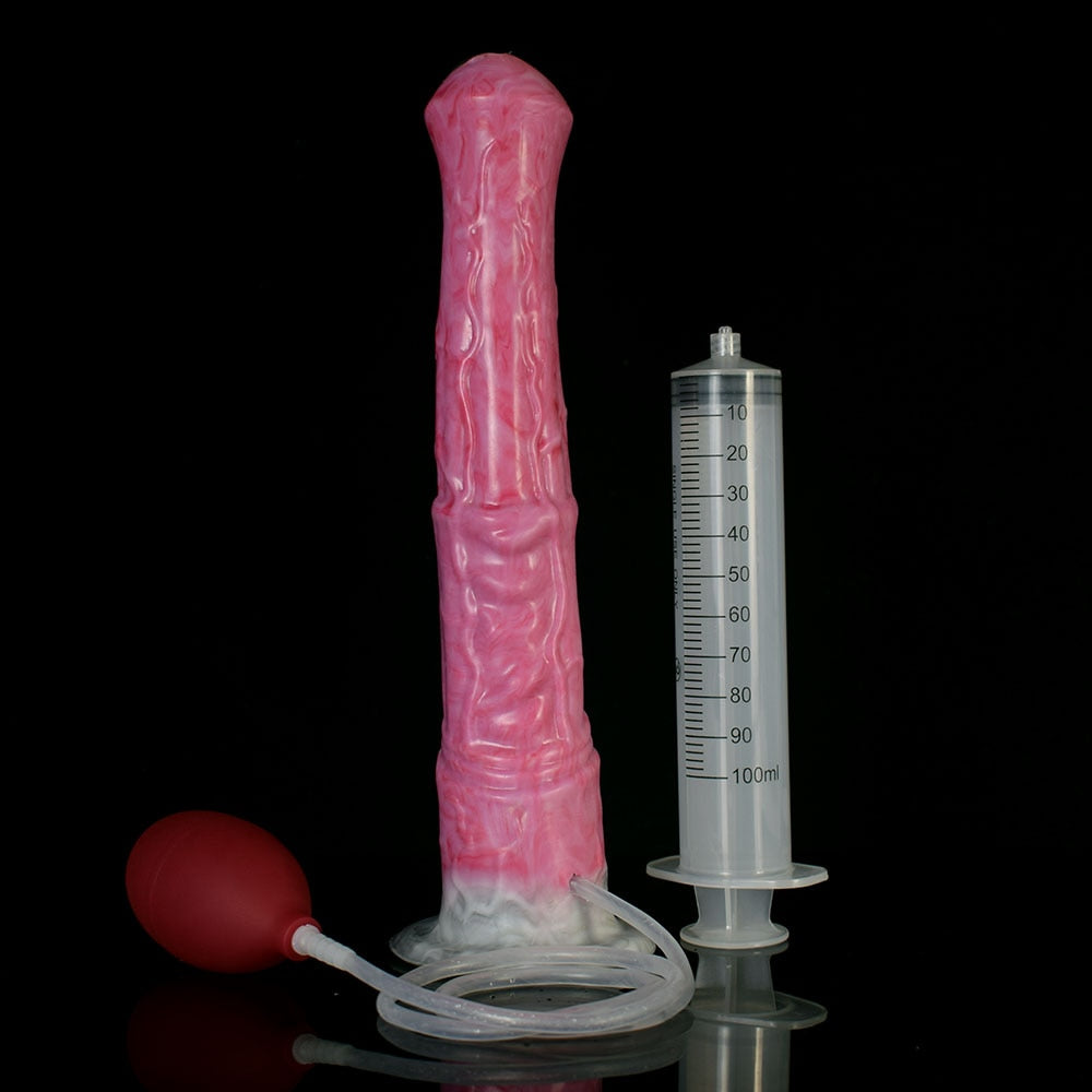 Pink horse dildo upright beside 100 ml measuring syringe and suction base