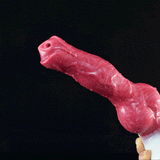 Canine-shaped sex toy with red-pink body, rounded base, and small nozzle detail