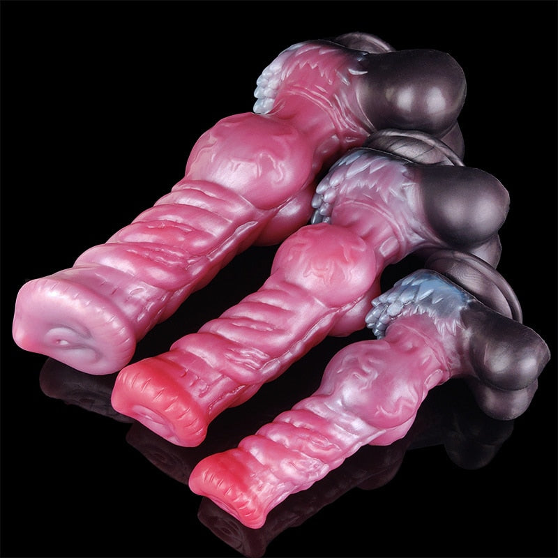 Pink ribbed werewolf-style dildo with dark suction base, side view detail