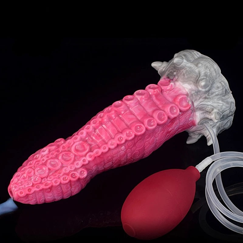 Pink octopus tentacle squirting toy with gray suction head, clear tube, and nozzle