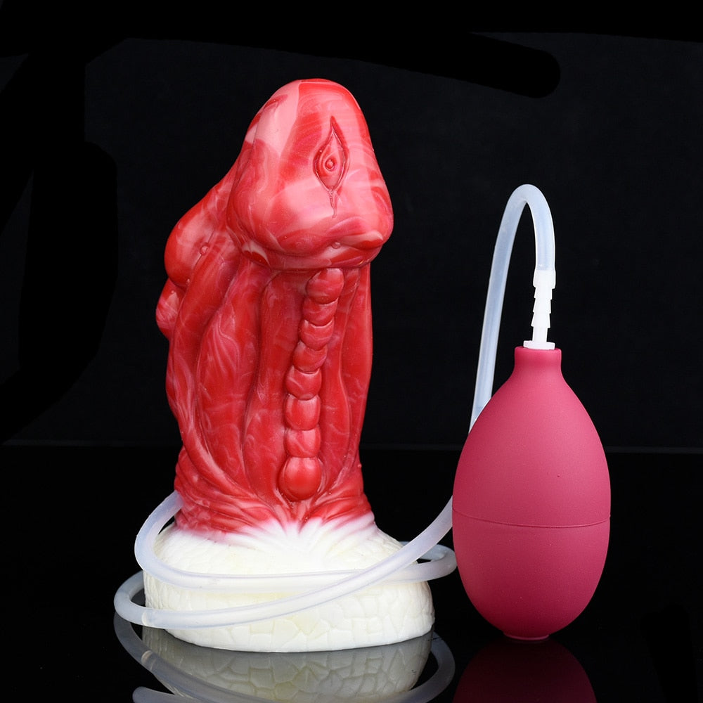 Red dragon anal plug with white base and maroon pump bulb with clear hose