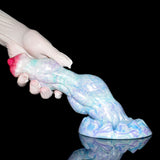 Pastel blue dildo with red tip, angled view showing knotted base details.