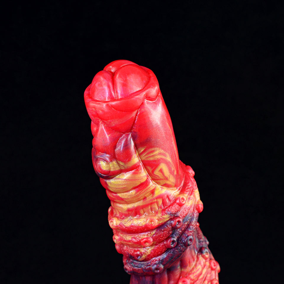 Head and upper shaft close-up: glossy red ribbed dragon dildo with dark metallic details