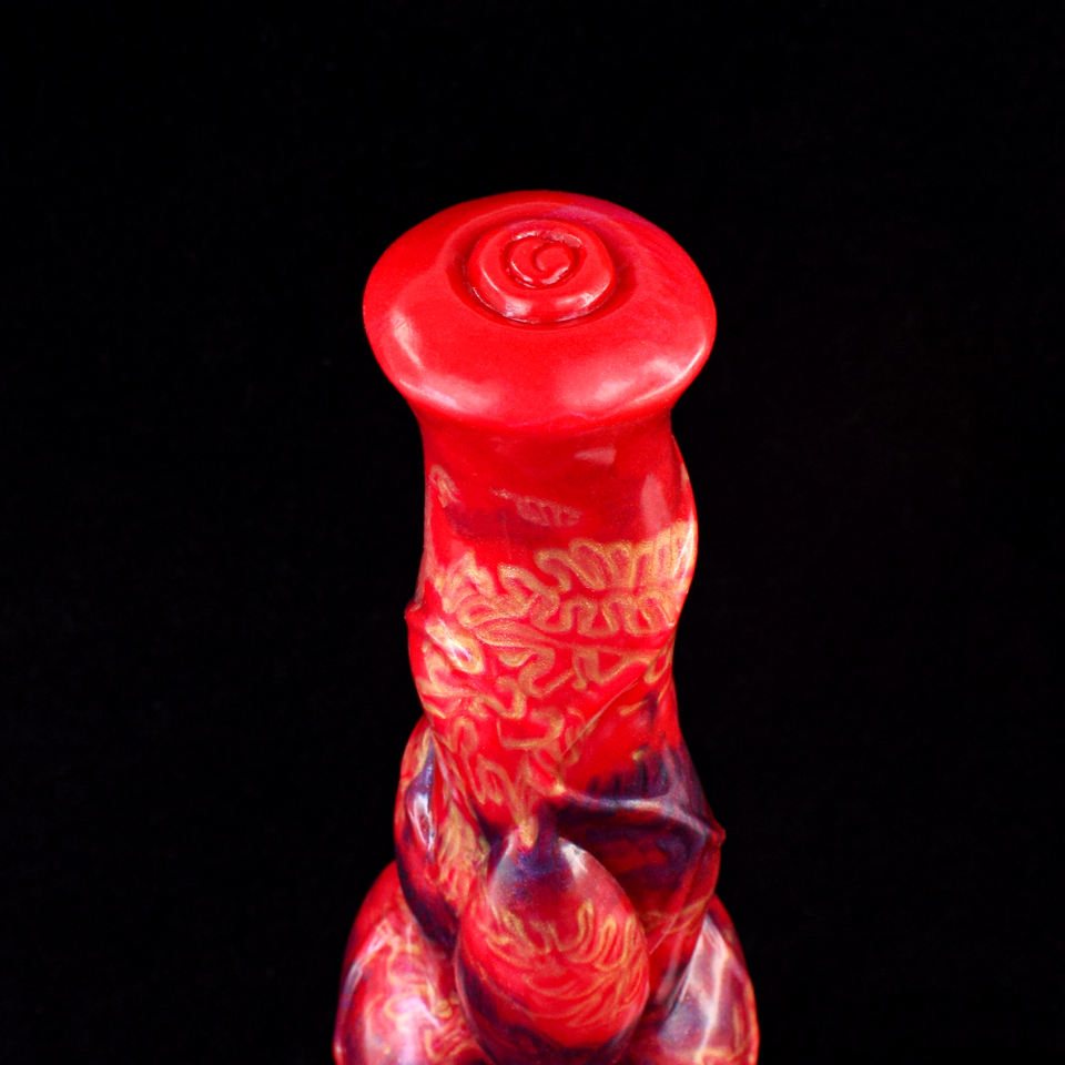 Close-up of red circular stopper on muscular horse-style dildo