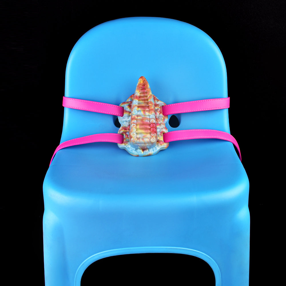 Tentacle toy on base with pink straps; rainbow tentacle head