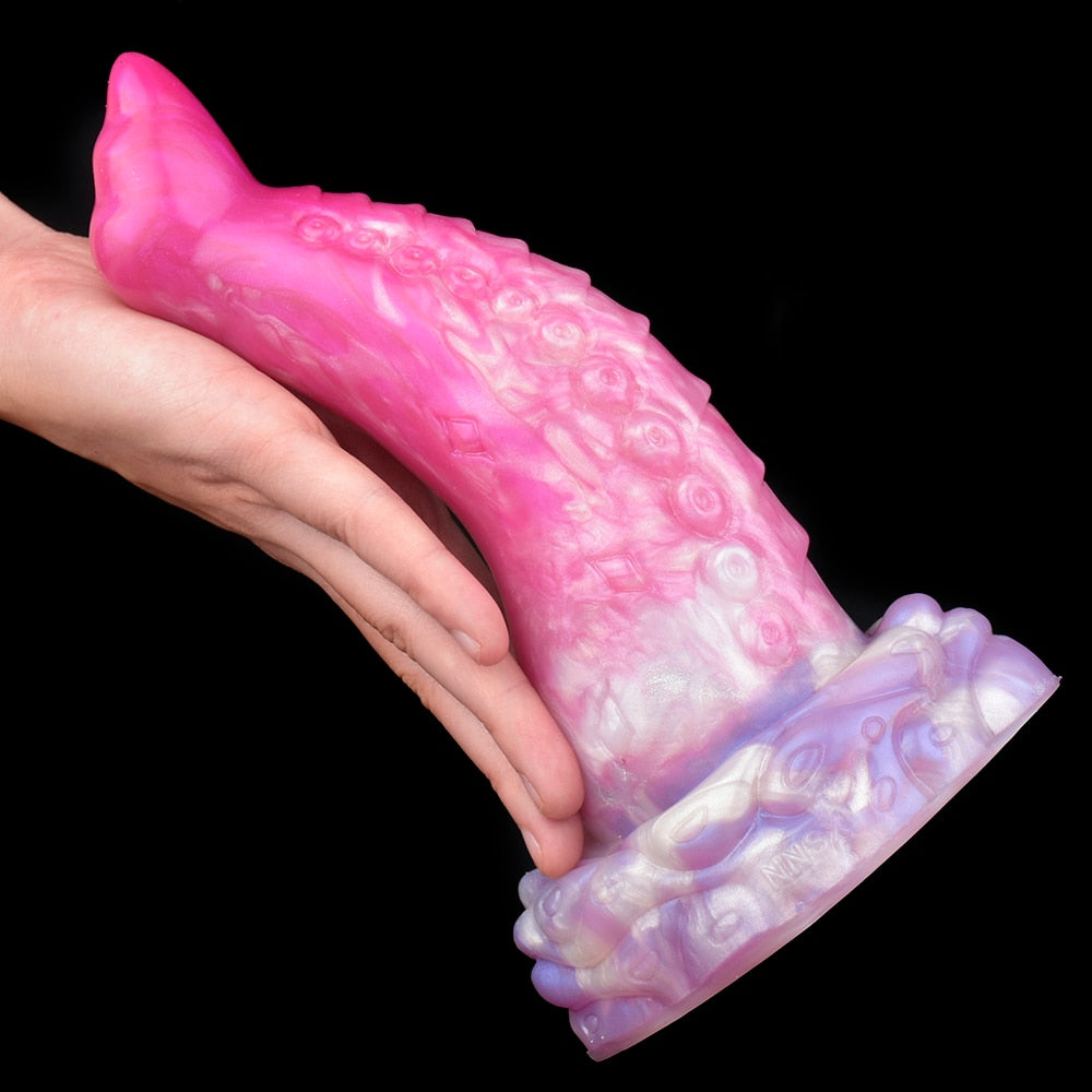 Close-up of curved octopus tentacle butt plug, pink translucent with suction-cup pattern