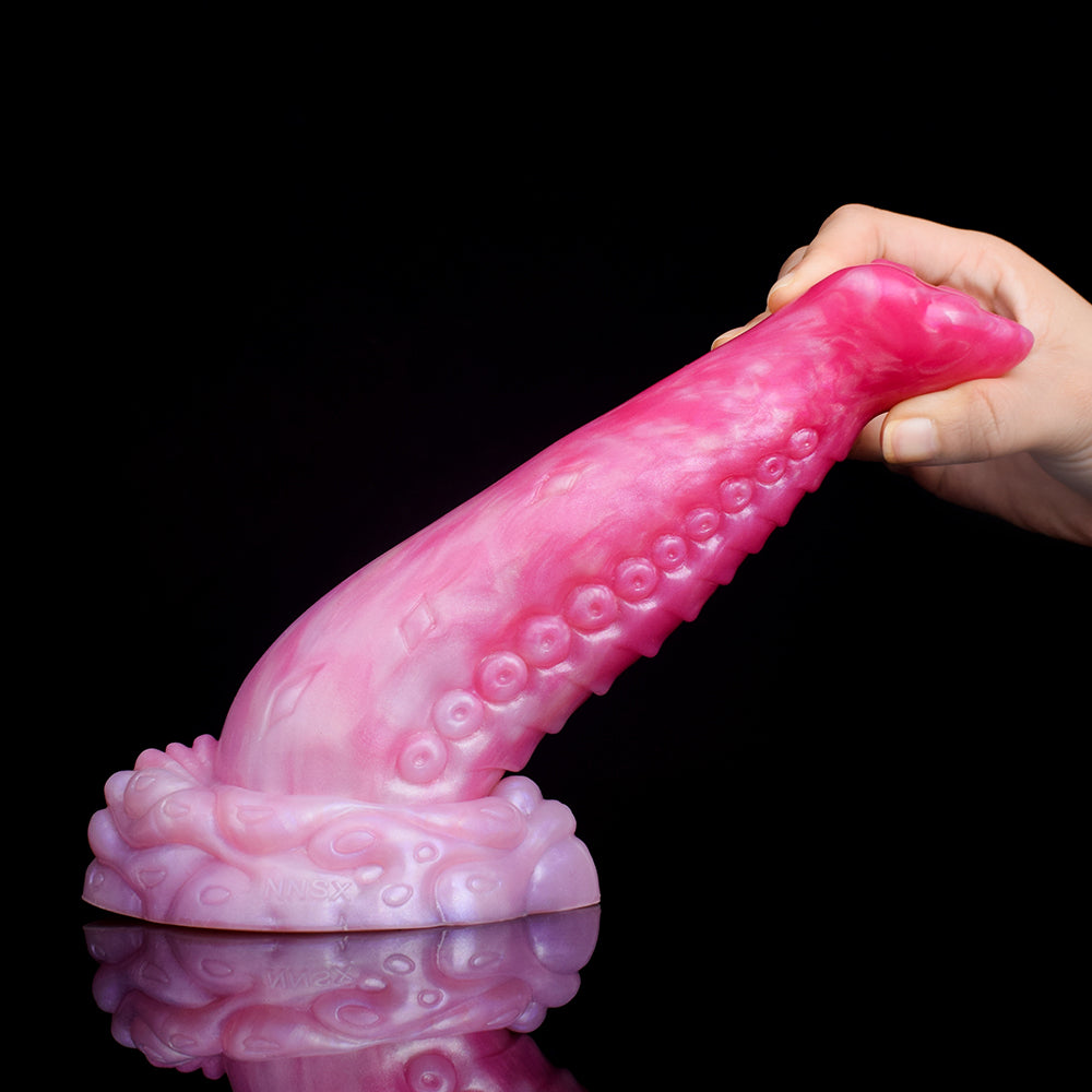 Side view of curved octopus tentacle butt plug, pink translucent with suction texture