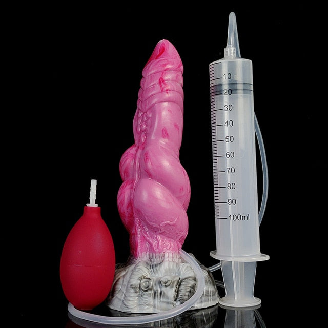 Pink double-knot silicone dildo with textured body, suction base, and syringe for size