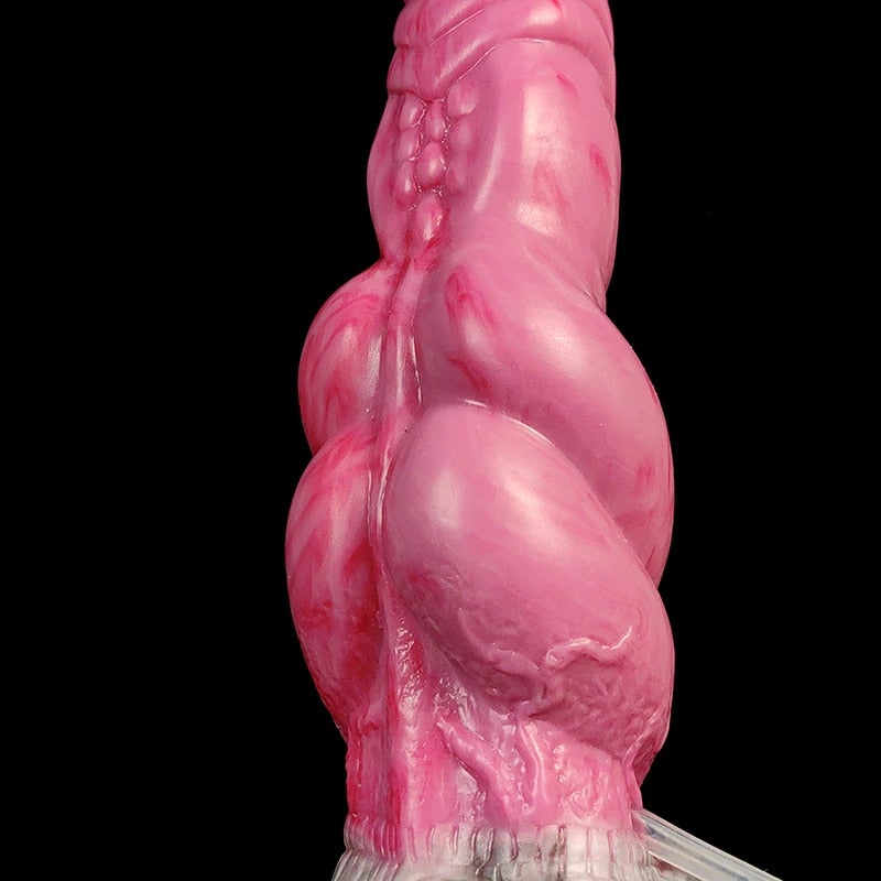 Close side view of hot pink alien double-knot dildo, textured knot details.