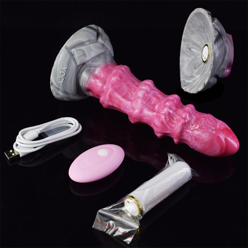 Pink ribbed silicone vibrator plug with grey base, remote and charging accessories
