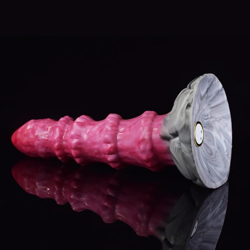 Pink ribbed octopus-style butt plug vibrator with gray circular motor base.
