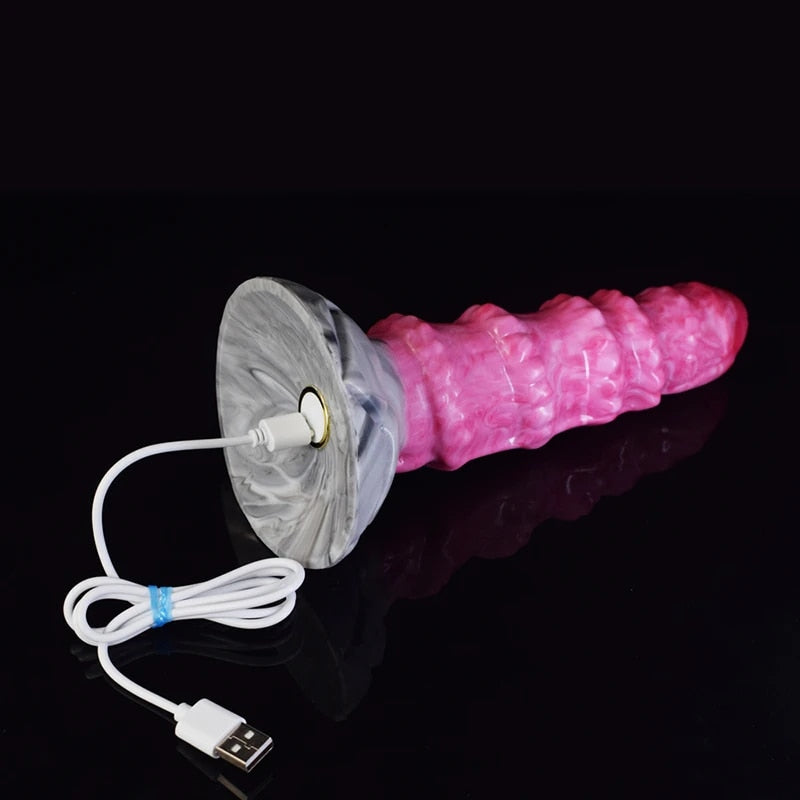 Pink ribbed octopus-style butt plug vibrator with gray base and attached power cord.