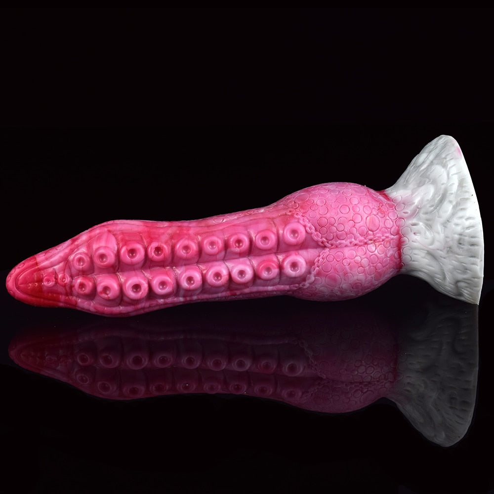 Fantasy octopus tentacle butt plug in pink, close side profile with suction-cup ridges