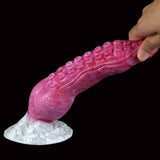 Fantasy octopus tentacle butt plug in pink, hand holding near the textured surface