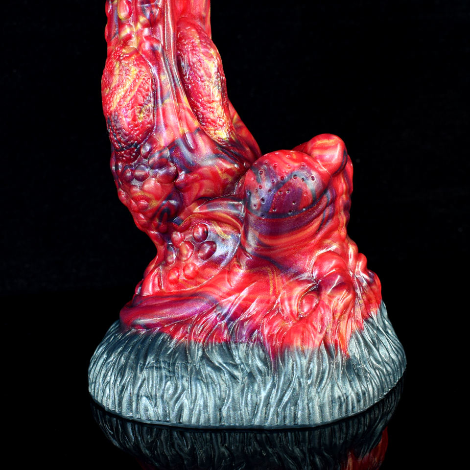 Close-up monster tongue anal dildo, red ridged surface and blue-gray base