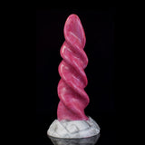 Pink spiral tentacle vibrator standing upright on white marble-look base, profile view