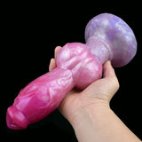 Pink dog-shaped sex toy with large purple knot and rounded head, hand-held