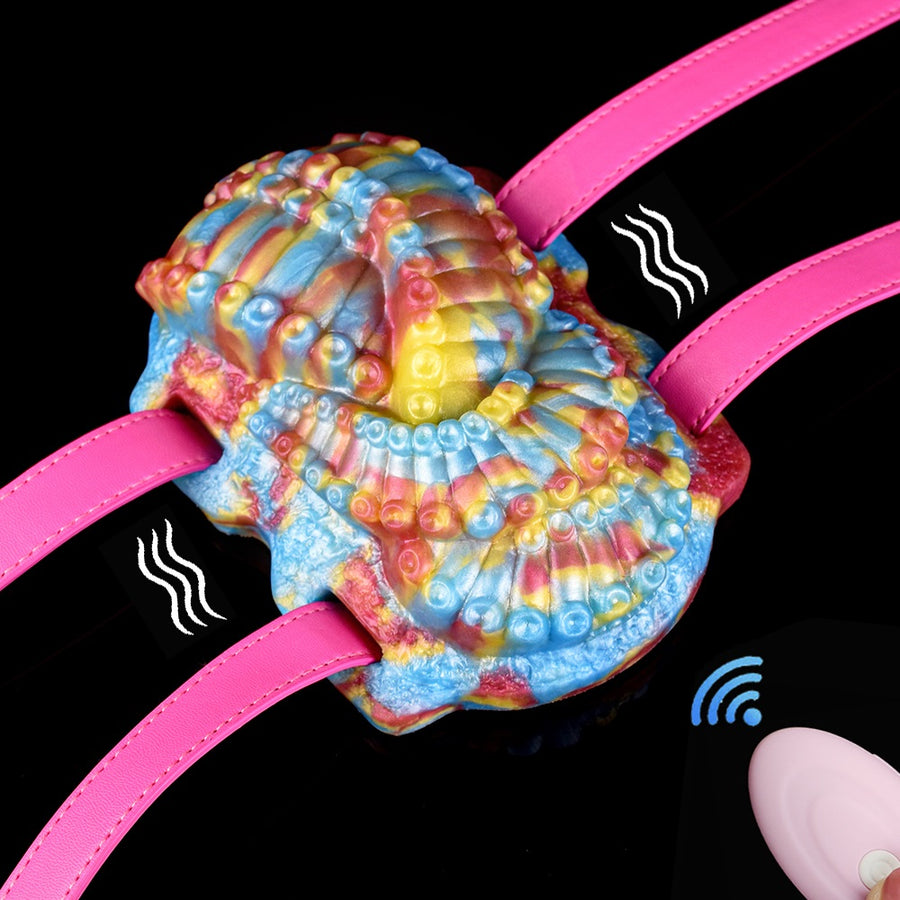 Thalis octopus grinder toy with rainbow textured body and pink straps, front view