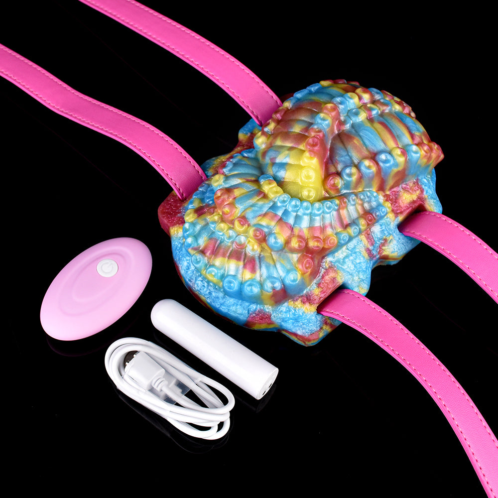 Octopus grinder toy with rainbow fabric, pink straps, and wireless controller