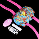 Octopus grinder toy with rainbow fabric, pink straps, and wireless controller