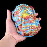 Rainbow octopus grinder toy, close-up front view with raised tentacle texture