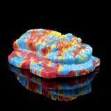 Rainbow octopus grinder toy, angled profile with ribbed underside