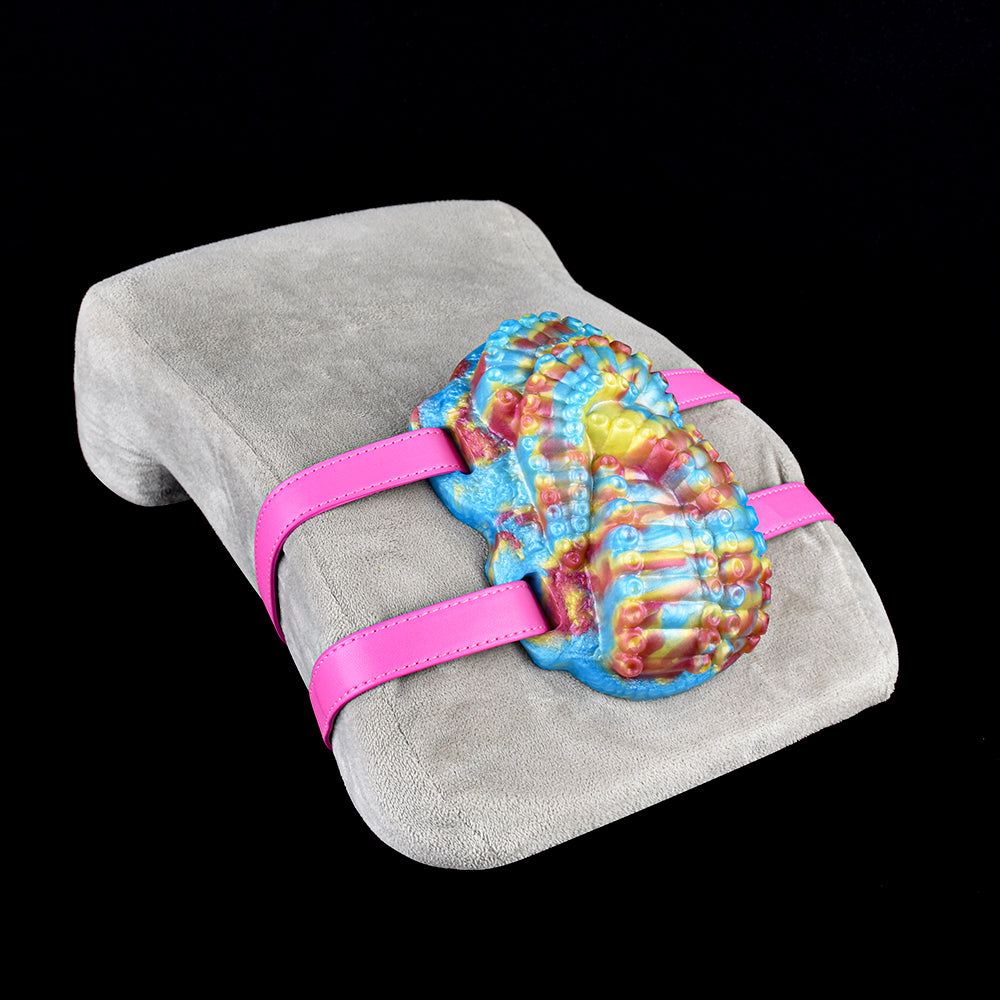 Octopus grinder toy on gray fabric with pink wrap-around straps