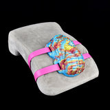 Octopus grinder toy on gray fabric with pink wrap-around straps