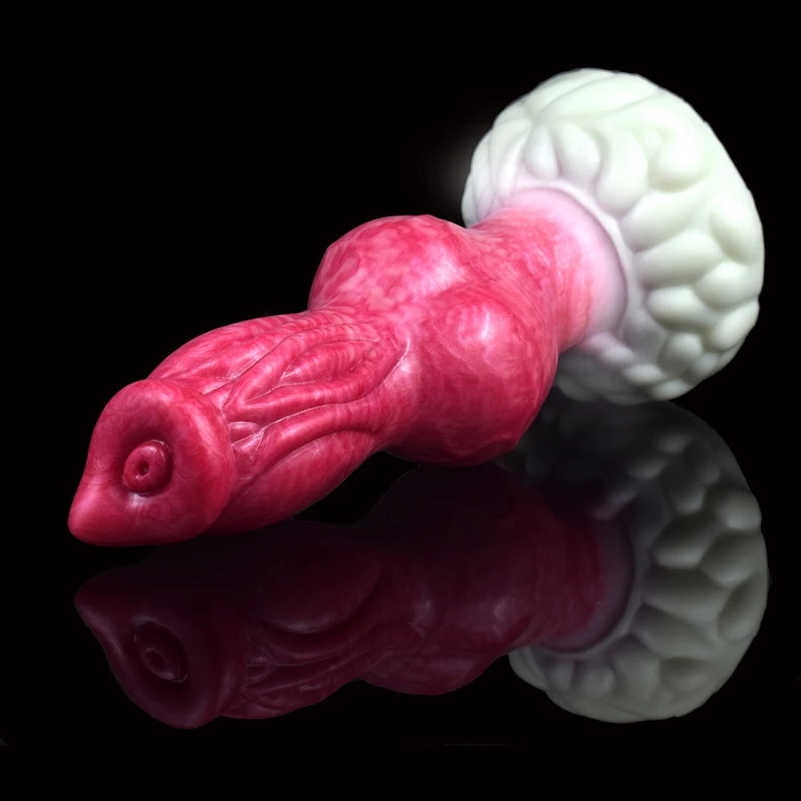 Knotted pink dog-shaped sex toy with textured white base, side view