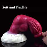 Turuk knotted dog dildo, soft flexible pink shaft held near the white base
