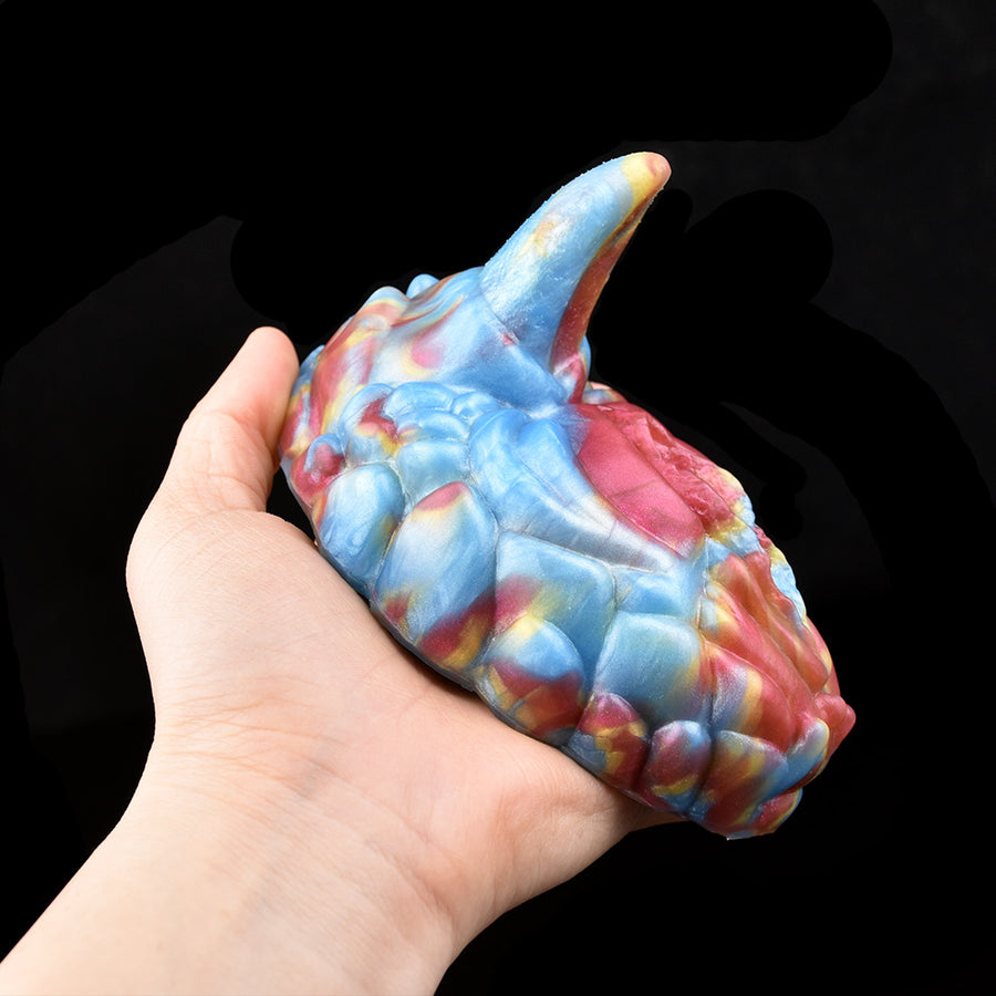 Patterned adult pleasure toy, blue and pink with ridged tip, held in hand