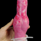 Pink translucent dog dildo held in hand, suction base visible